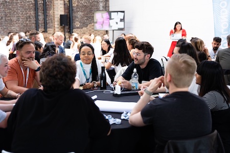 Attendees gathered around a table at a workshop.